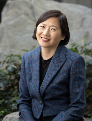 Rachel Joo Short, straight, dark hair. Wearing black shirt and woven black and blue jacket