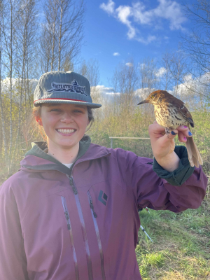 Bella Wissler smiling, holding a bird