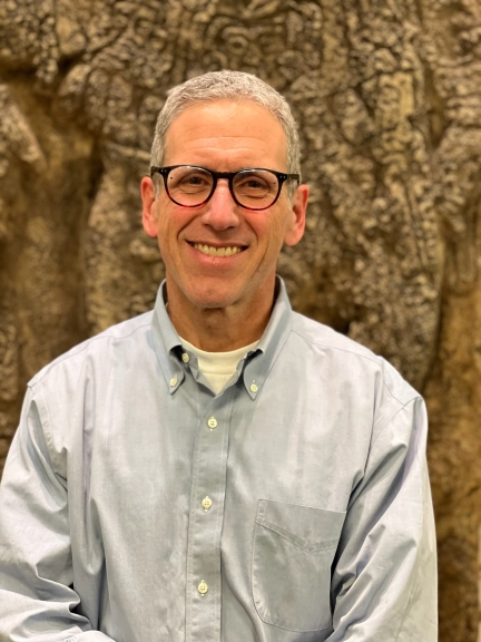 Man with glasses and blue shirt