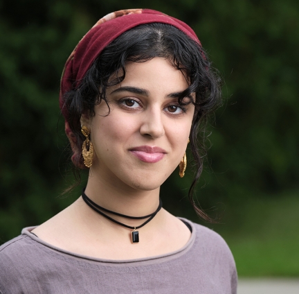 Saifa wearing black necklace and lavender top