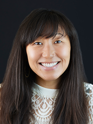 2022 headshot of Lori Mackey, wearing a white lace shirt