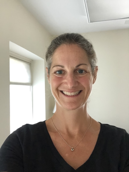 Smiling woman against a bright, white backdrop