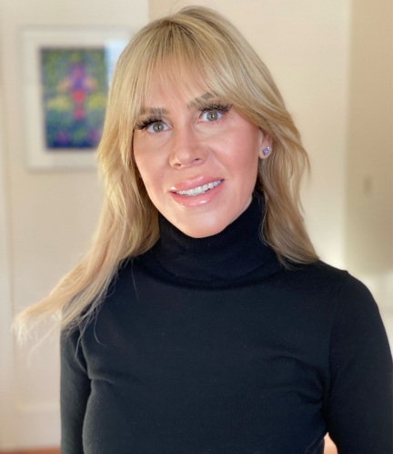 Professional photo of a smiling blond woman in a black turtleneck