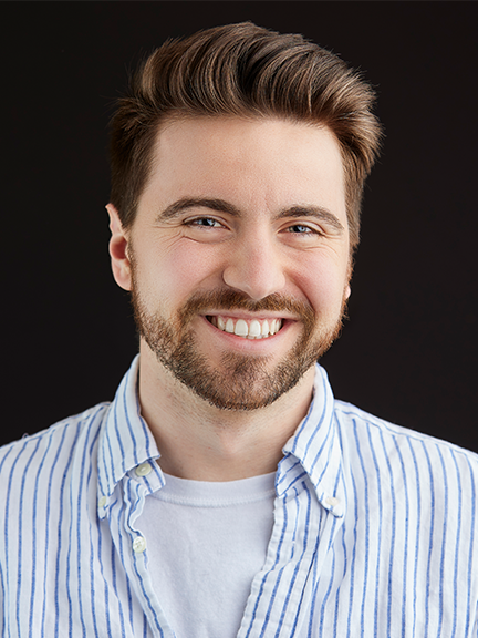 Devin Mcgrath-Conwell in a striped blue button shirt.