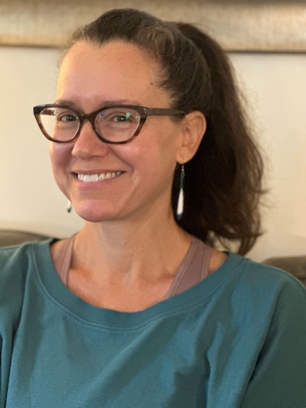 A Smiling woman wearing glasses