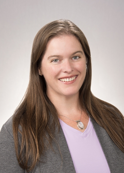 Smiling woman against a gray backdrop