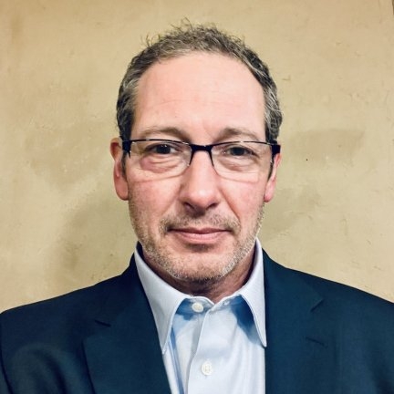 Male with short hair, glasses with suit jacket