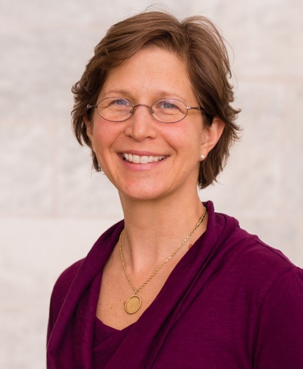 Amy Morsman headshot smiling with glasses