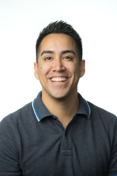 A Smiling Man with Dark hair and dark eyes on a white background