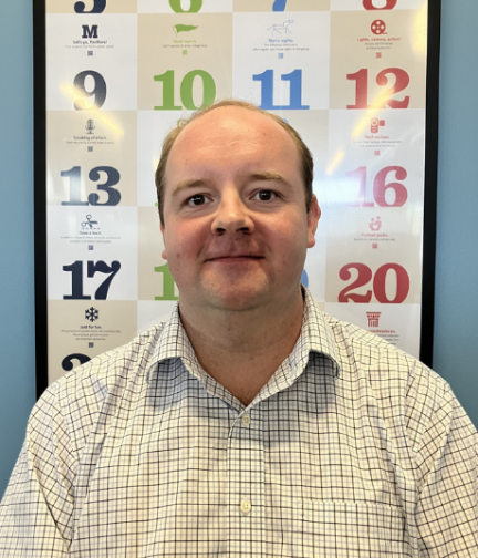 photo of HR staff member in front of numbers background 