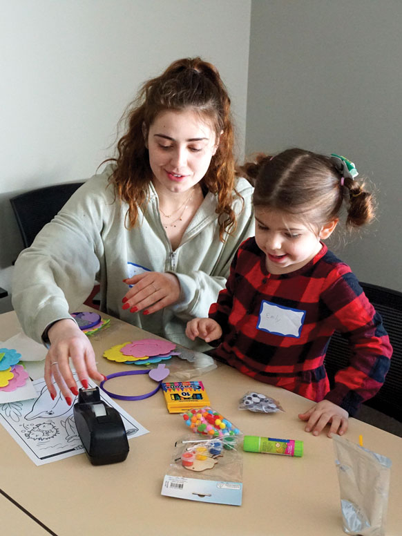 A student works with a child in a local elementary school.