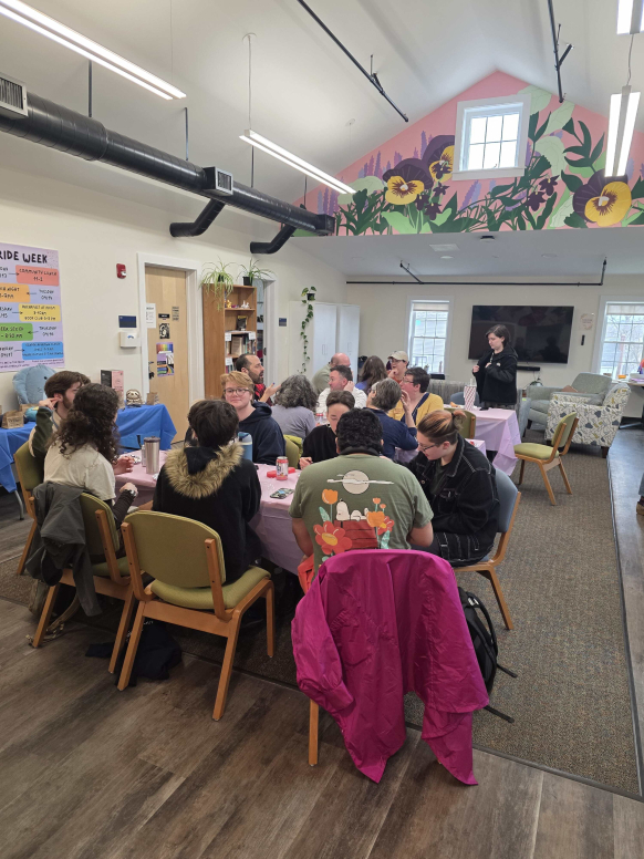 Group of students seated at a table enjoying a shared crafting activity