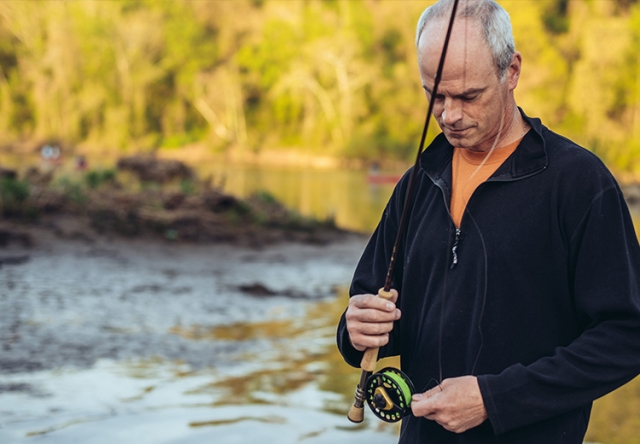 Portrait of Chris Wood Fishing in a river