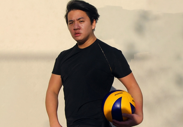 Photo of Jesse Birdsall holding a basketball while wearing an athletic shirt