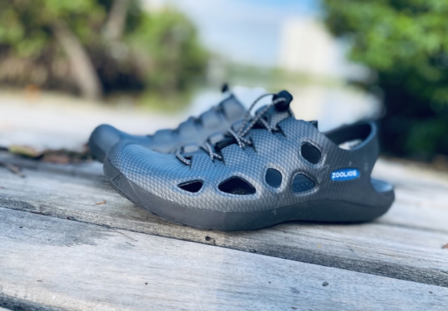 Rubber sandals resting on a wooden, outdoor table