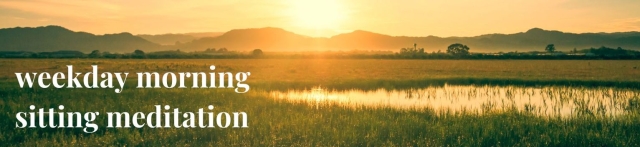 sunrise above green hills with pond