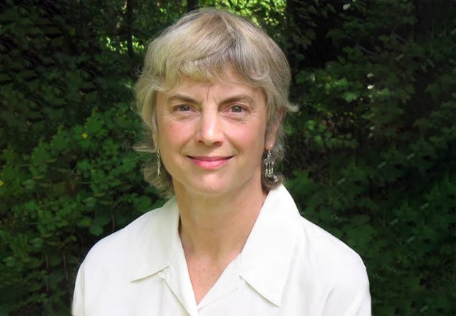 Photo of Former Bread Loaf Faculty member Marjorie Ryerson in front of green shrubbery