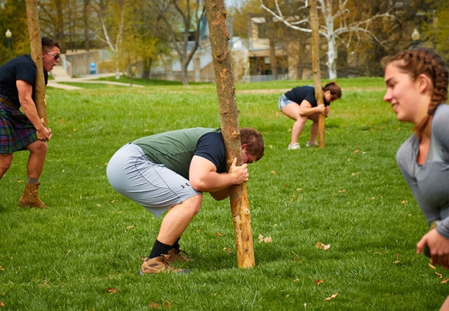 Students lifting logs and rocks for first annual highland games