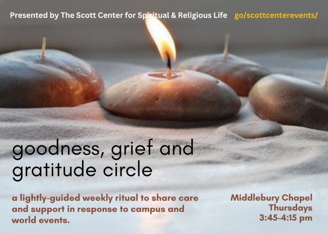candles set in smooth round stones on a bed of sand