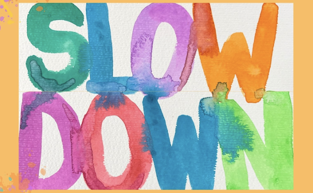 multi colored watercolor of words Slow Down