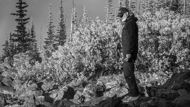 Black and White of Geology Professor Jeff Munroe Outside on a mountain.