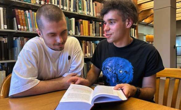 Amir Balafendiev (SF26), left and Kanstantsin Tsiarokhin (SF25), at right, study a book together..