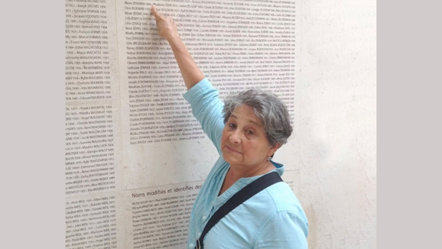 Renée Fauguet-Zejgman points to her father’s name on a memorial in Paris. Sarah Federman