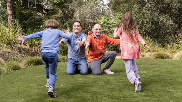 Two Fathers Embrace Their Children