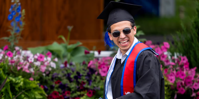 Bibatshu Thapa Chhetri '25 smiles exuberantly as he receives the Condon Medal during Colby's 204th Commencement.