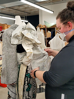 Shannon Palmer tying an elaborate bow on the obi of a kimono