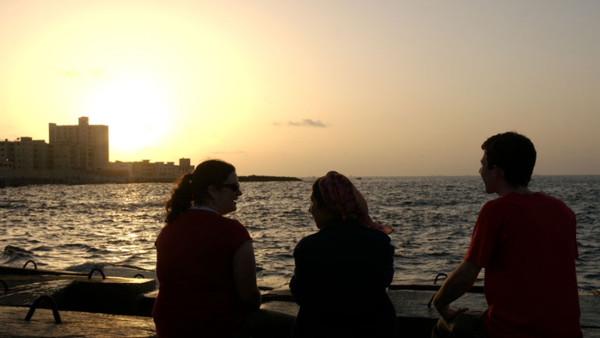 People silhouetted by a sunset.