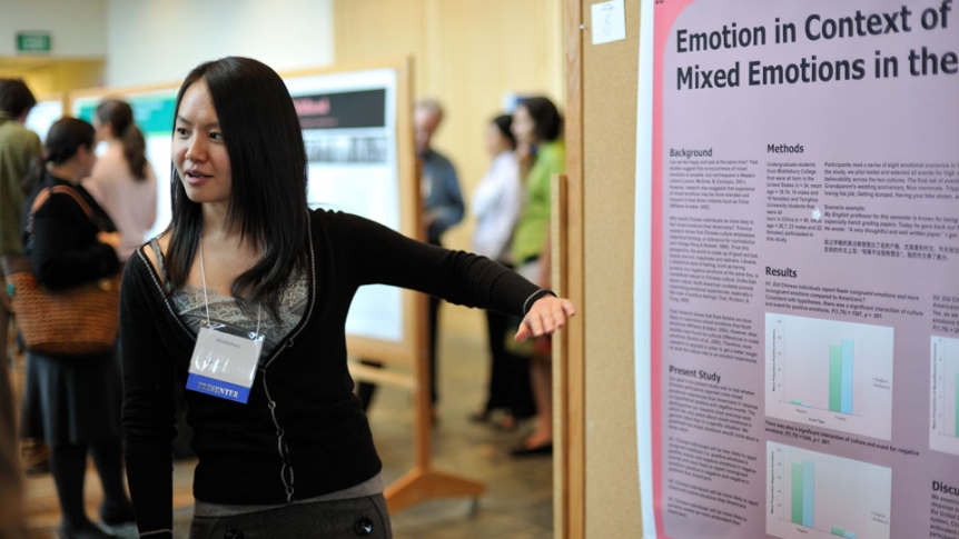 A student presents her research projects using a poster presentation.