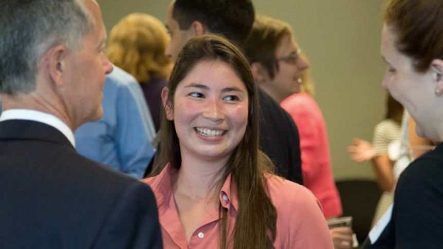 A recent alum talks with faculty in the DC office.