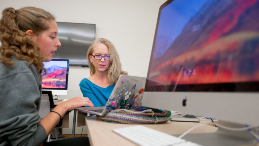 A research assistant helps a professor compile and organize data.