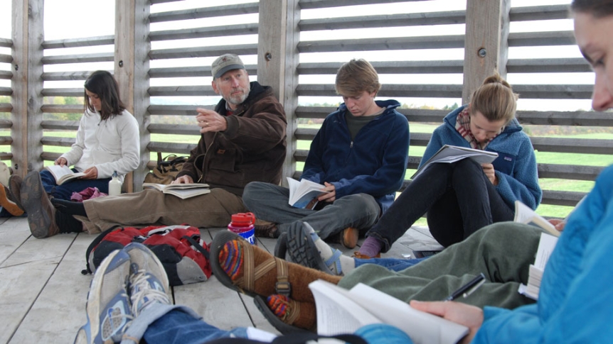 A professor teaches a class in the shelter at the Organic Garden.