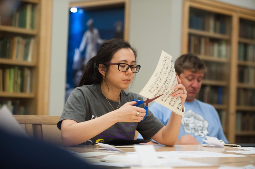 Female student cutting paperStudents participate in a Book Arts Lab in Special Collections.