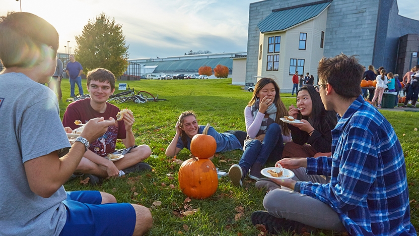 Five Middlebury students sit outside during Harvest Fest