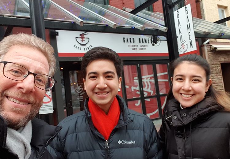 Owner of Gaku Ramen in front of restaurant with his children