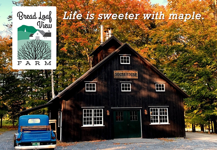 Photo of a rustic brown barn with an old blur pickup truck parked in front