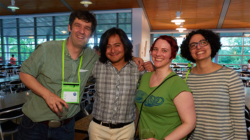 four people in casual summer clothing link arms and smile at a Class of 1997 gathering during Reunion 2017