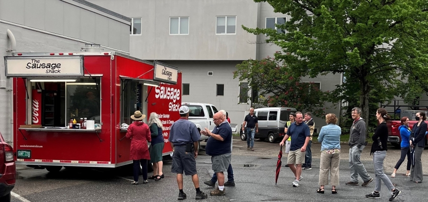 Employees wait in line for a breakfast sandwich