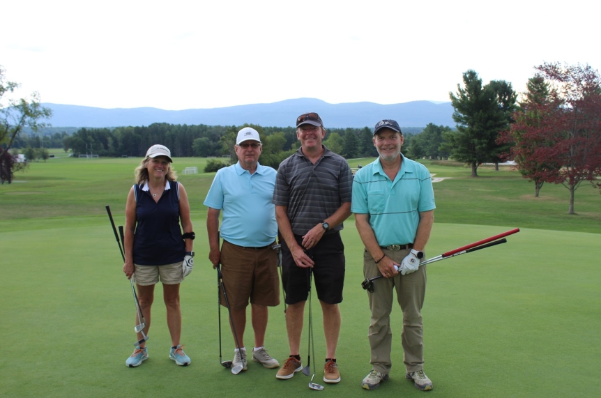 team photo from employee golf tournament