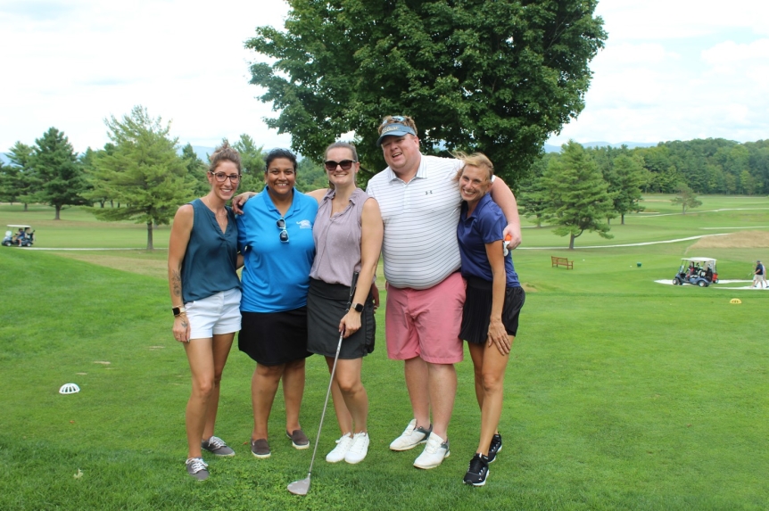 team photo from employee golf tournament
