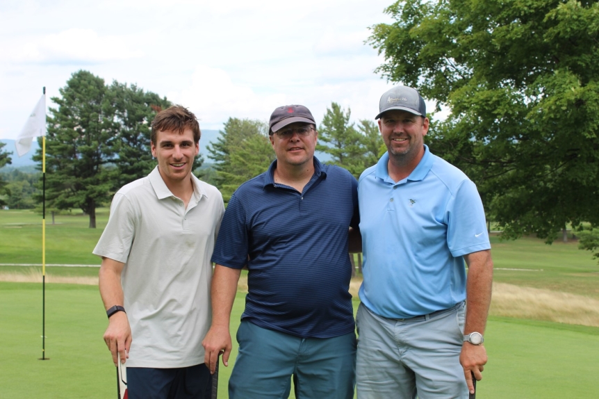 team photo from employee golf tournament