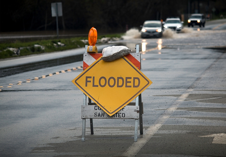 Flooded Street with Road Sign