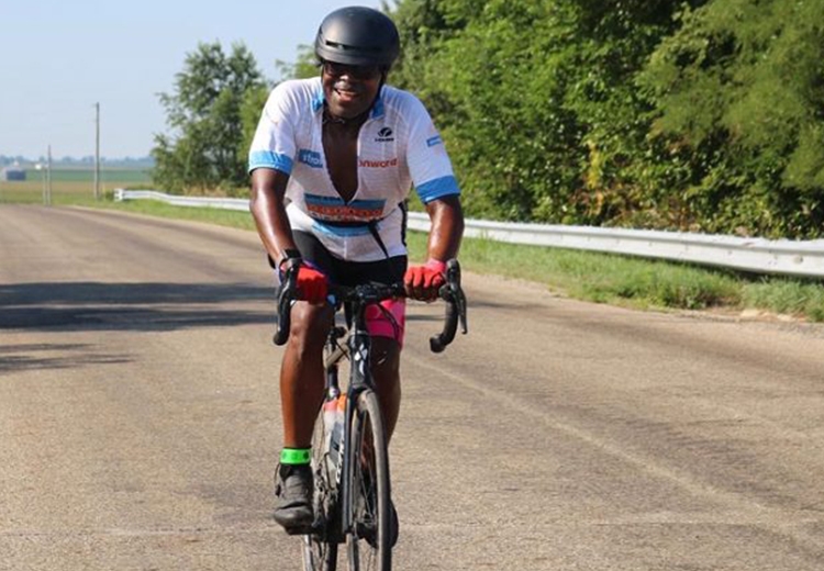 Michael Obel-Omia riding a bike down an empty street