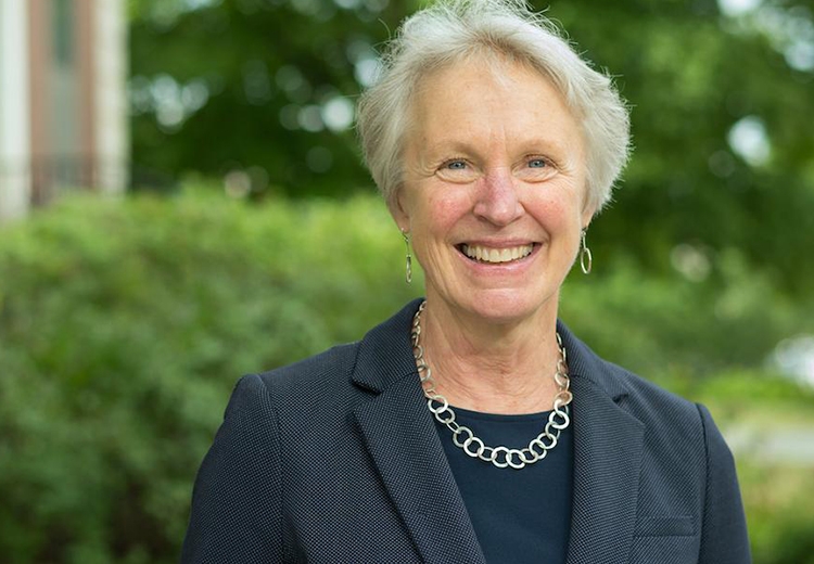 Portrait of Katharine Shepherd ’78 in front of green shrubbery