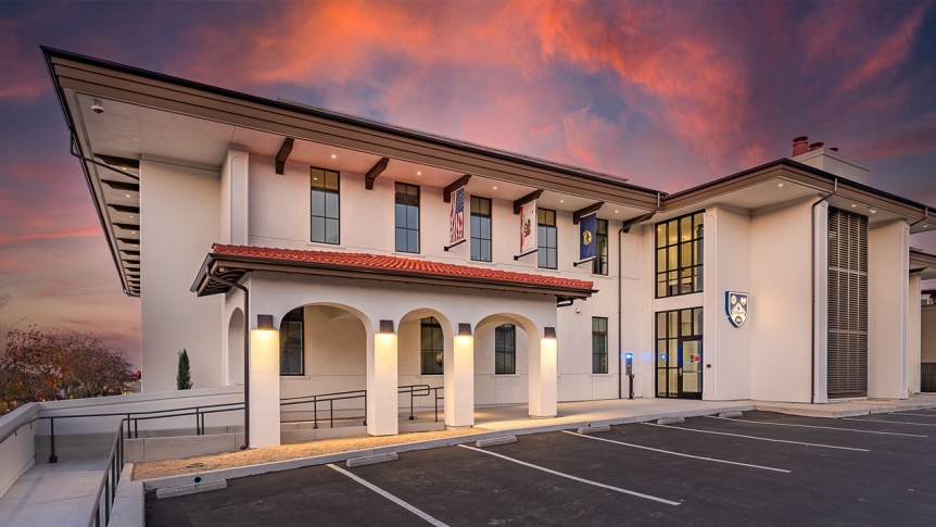 The outside of the student dorm with a sunset in the background