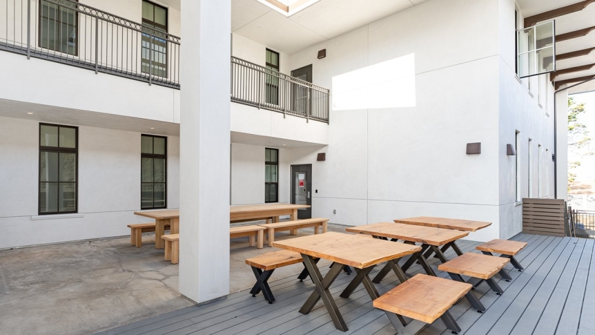 An outdoor deck with tables and benches