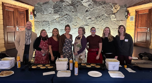 Photo of Staff members serving pancakes